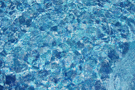 Background of transparent blue in pool water top viewの写真素材
