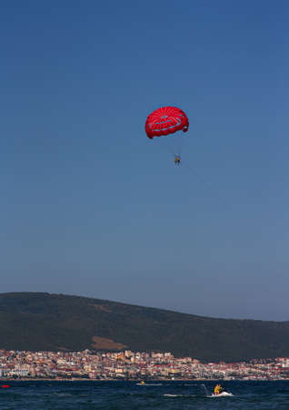 Parasailing with a boat over the sea vertical photoの写真素材