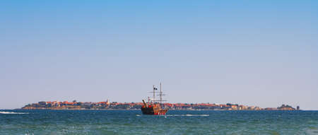 Historic pirate ship in the ocean near the islands and beautiful panoramaの写真素材