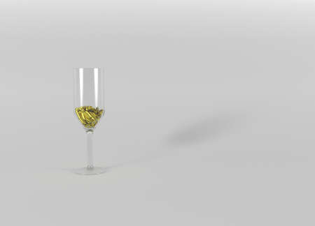 A glass with gold bimetallic coins on a gray background.の写真素材