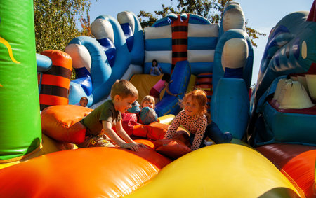 Children play on an inflatable slide in Loshitsky Park on the day of the city of Minsk 2021.のeditorial素材