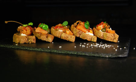 Sandwiches or tapas of bread red caviar and red fish with micro greens, seafood Luxury delicacy foodの写真素材