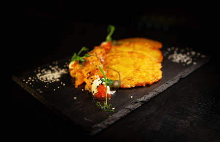 Potato fritter pancake with red caviar, salmon in luxury restaurantの写真素材