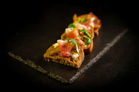Whole grain bread sandwiches with ham, bacon, prosciutto, olives and olivesの写真素材