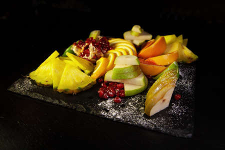 Assorted fruit on a black backgroundの写真素材