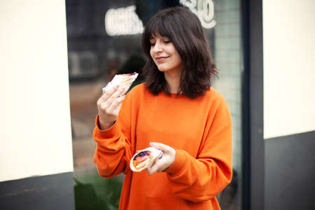 A young smiling girl holds vegetarian rolls.の写真素材