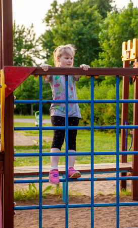 A young girl in the park on the playgroundの写真素材