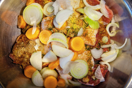 A raw sliced meat, pickled with spices, and vegetables for further cooking.の写真素材