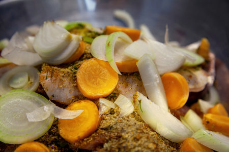 A raw sliced meat, pickled with spices, and vegetables for further cooking.の写真素材