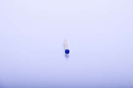 matchsticks in front of blue white backgroundの写真素材