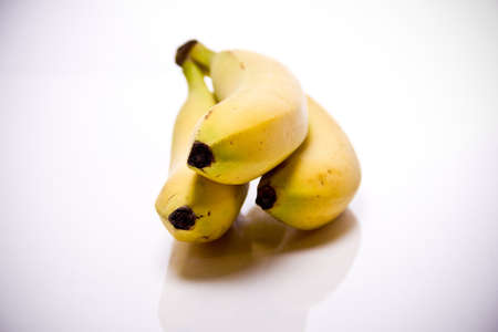 bananas shown in front of white backgroundの写真素材
