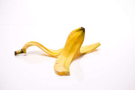 a banana skin in front of white backgroundの写真素材