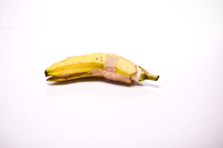 a opened banana in front of white backgroundの写真素材