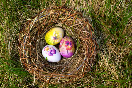 easter eggs painted flowers on the nestの写真素材