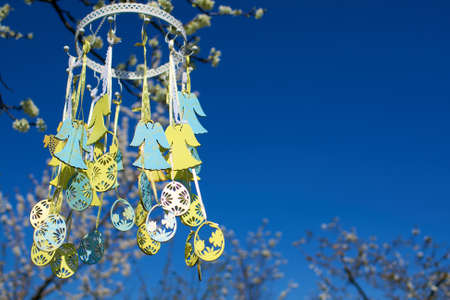 Easter toys on flowering tree in spring