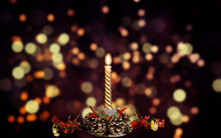 Burning Christmas candles on a wooden table. Symbol of peace.の写真素材