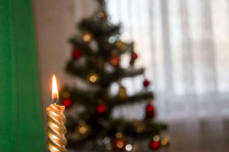 Burning Christmas candles on a wooden table. Symbol of peace.の写真素材