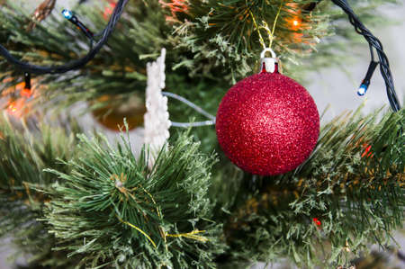 Multicolored Christmas balls, toys and garland on the Christmas treeの写真素材