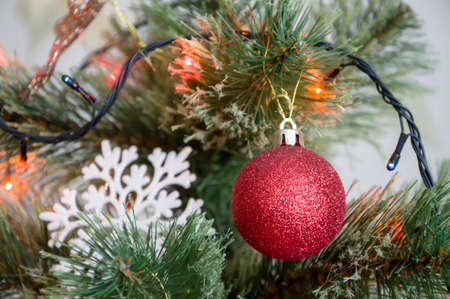 Multicolored Christmas balls, toys and garland on the Christmas treeの写真素材