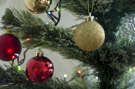 Multicolored Christmas balls, toys and garland on the Christmas treeの写真素材