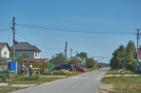 Residents of a modern village in summer on a village streetの写真素材