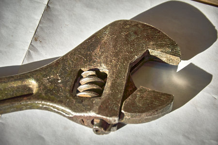 An old rusty wrench on a piece of paperの写真素材