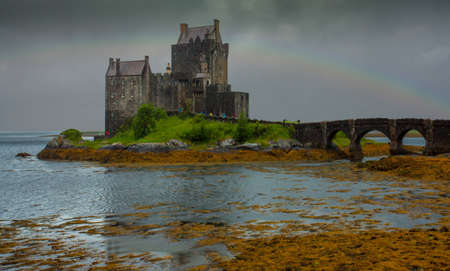Eilean Donan Castle and gloomy rainclouds and rainbowのeditorial素材