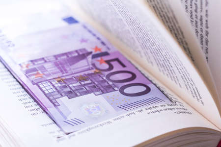 Hide euro banknotes in the book finance saving Moneyの写真素材