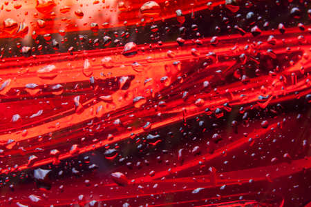 Red glass stripes design Background with water dropsの写真素材