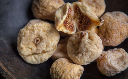 dry figs in rustic wooden bowl dry fruits close up food still lifeの写真素材