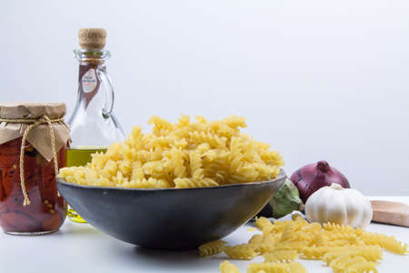 Pasta cooking ingredients concept on white traditional Mediterranean foodの写真素材