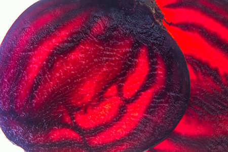 fresh red beet slices translucent food macro on lighted backgroundの写真素材