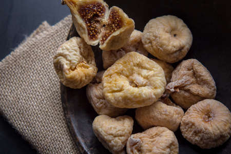 dry figs in rustic wooden bowl dry fruits close up food still lifeの写真素材