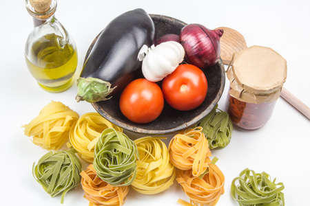 Pasta cooking ingredients concept on white traditional Mediterranean foodの写真素材
