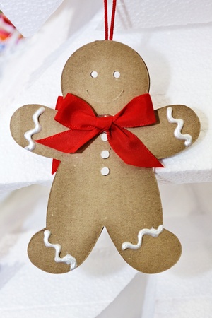 Little paper puppet made as christmas decoration, smiling for christmasの写真素材