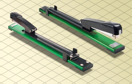 ISOMETRIC Photograph Isolated on grid and yellow background of a Green and Black Long Stapler の写真素材