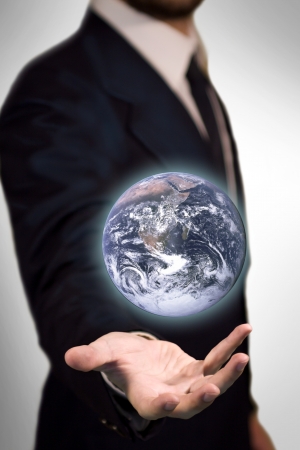 Earth Sphere in the palm of a business man like a magic sphereの写真素材