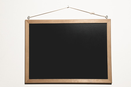 A plain black blackboard, ready to be filled of text and words to start the lesson 