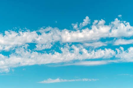 Turquoise blue sky with white clouds.の写真素材