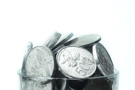 A picture of glass fill with coinの写真素材