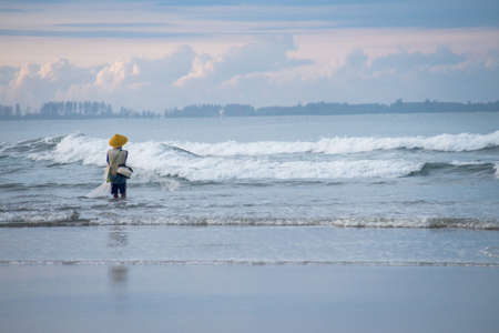 Fisherman on Seaside doing his job catching fishの写真素材