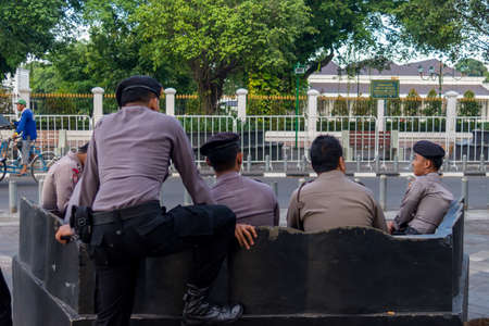 Police officers sitting on benchのeditorial素材