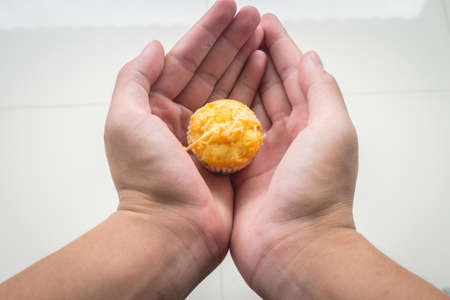 Anonymous Person Holding Sweet Cheese Cupcakeの写真素材