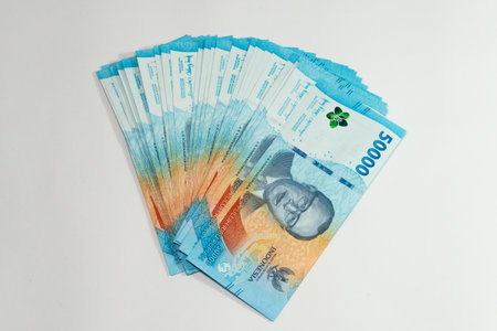 Stack of Indonesia currency money of 50000 rupiah on white backgroundの写真素材