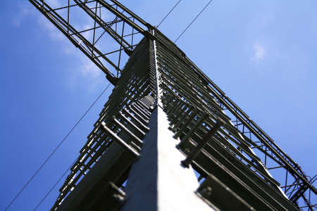 Electric pylon with the wires in front of blue sky