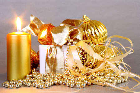 Golden Christmas decoration with candles on silver backgroundの写真素材