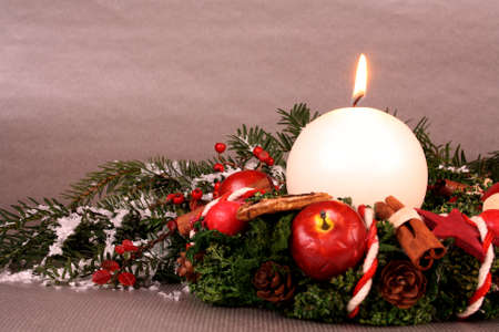 Christmas wreath with candle and Christmas decoration on silver backgroundの写真素材