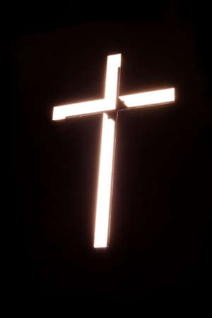 Glowing cross on a black background church
