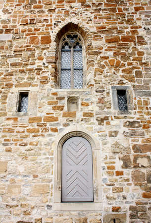 Old church facade of brick with window and doorの写真素材