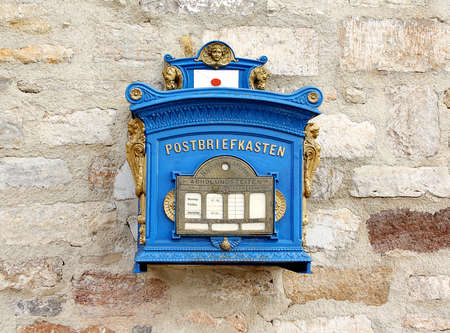 Old blue german mailbox on the brick wall, closeupの写真素材
